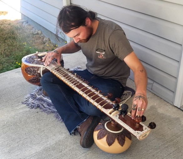 Nicolas tuning his sitar.